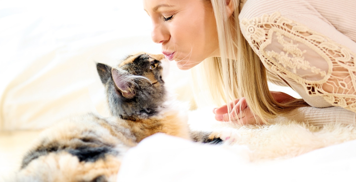 Nahaufnahme von einer Frau die ihre Katze küsst on Location